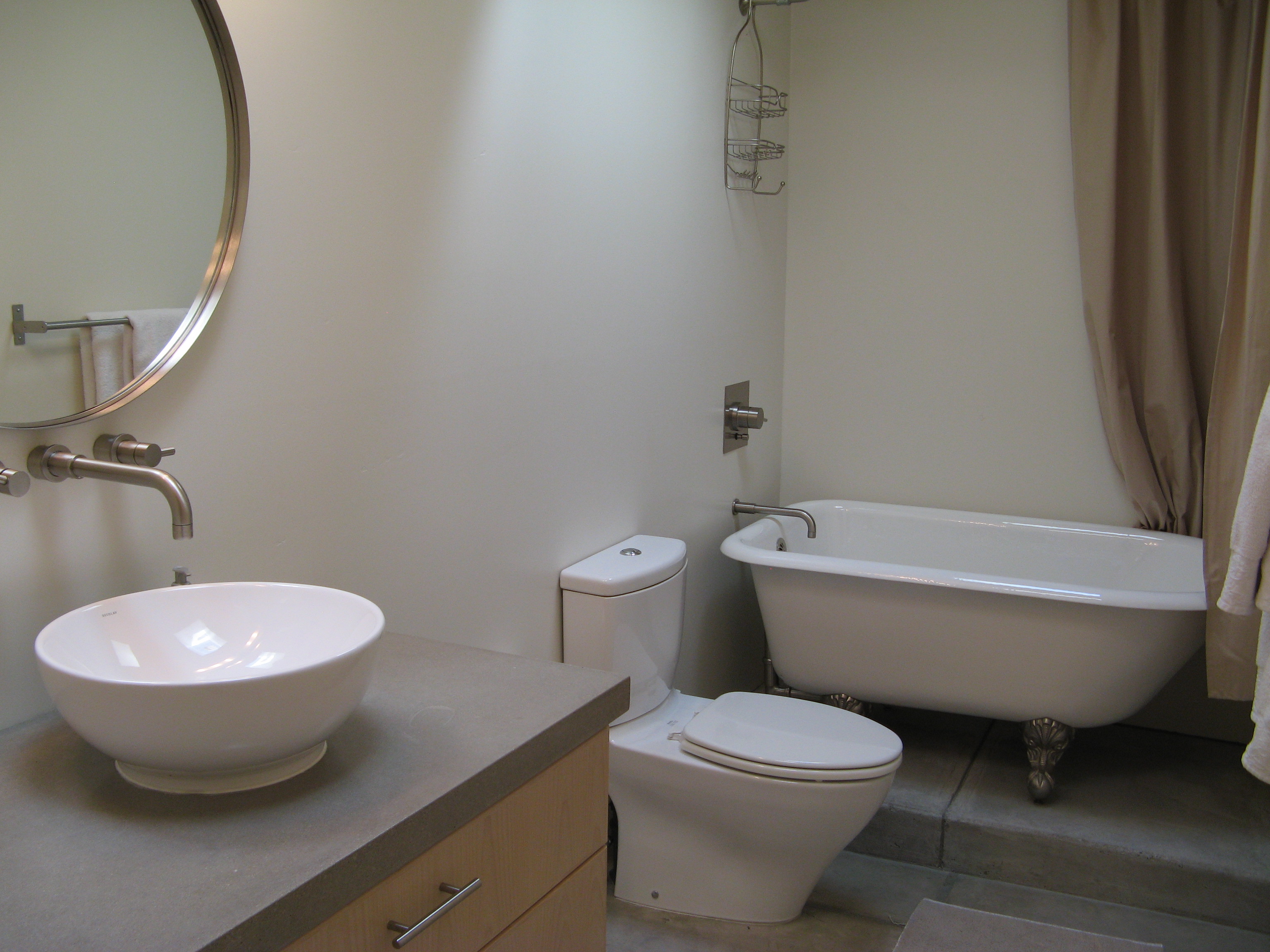 Modern, contemporary fixtures juxtaposed with a vintage claw-foot tub