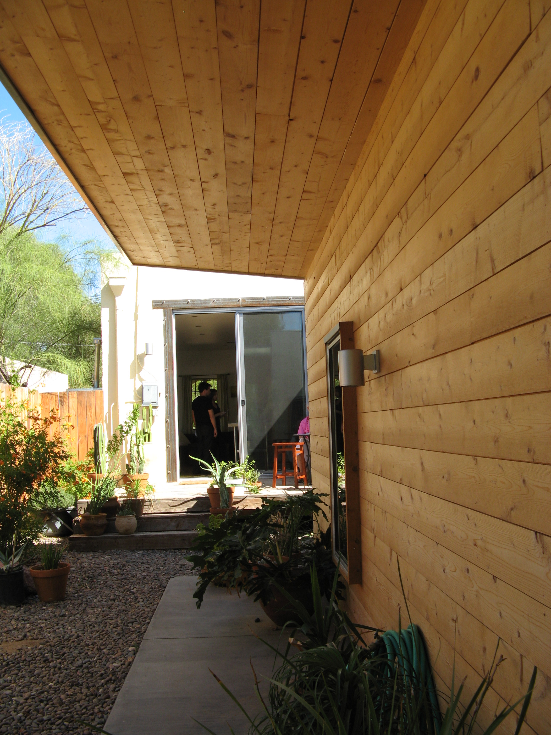 New, wood portion of home addition to a historic stucco home in the Sam Hughes neighborhood