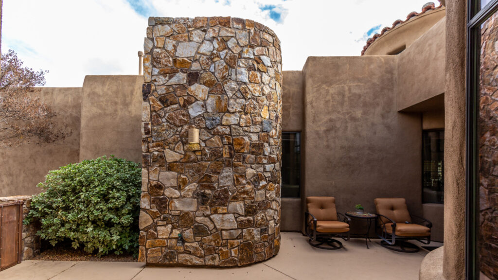 A home in Stone Village featuring a curved rock wall
