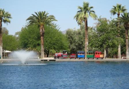 A kid's train ride going around one of the two lakes at Reid Park, located in central Tucson, Arizona.