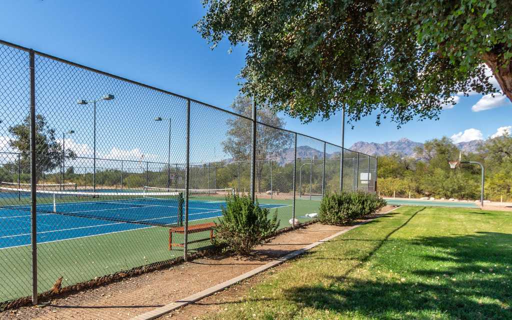 Tennis and basketball courts are near a playground and a second pool.