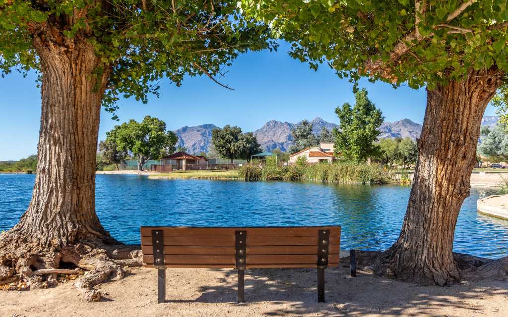 Park bench on the shores of one of the lakes in Lakes of Castle Rock neighborhood in Tucson