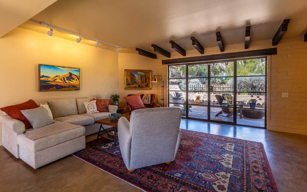 Living room in Catalina Townhouses, in Tucson Arizona. The beams above the exterior doors are a classic design element used by Juan Worner Baz