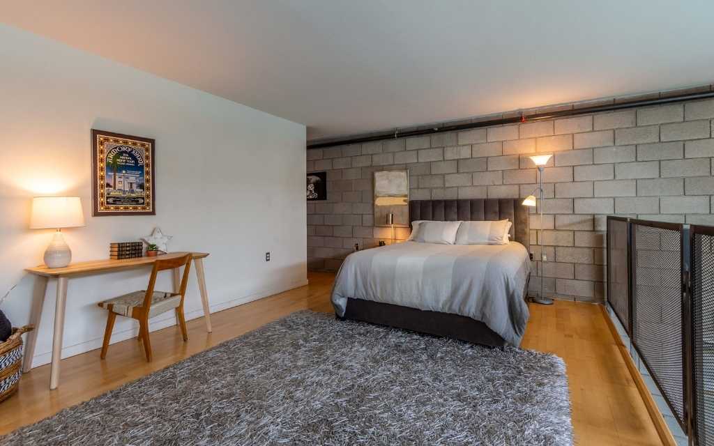 This Ice House Loft unit features an expansive loft space overlooking the great room below.