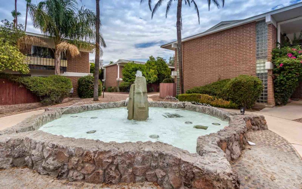 This Moai head fountain is a focal point at Eden Roc Gardens, a 1960s midcentury modern community featuring split face concrete block construction.