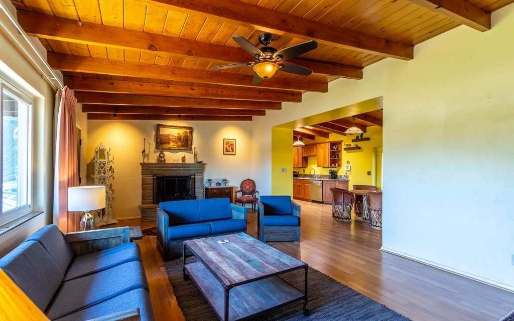 Midcentury ranch home with lots of charm for sale in Tucson Arizona. Living room with wood beam ceilings