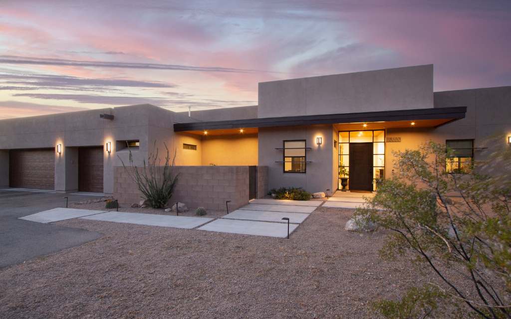 Contemporary home in Tucson Mountain Reserve at dusk with pretty Arizona sunset