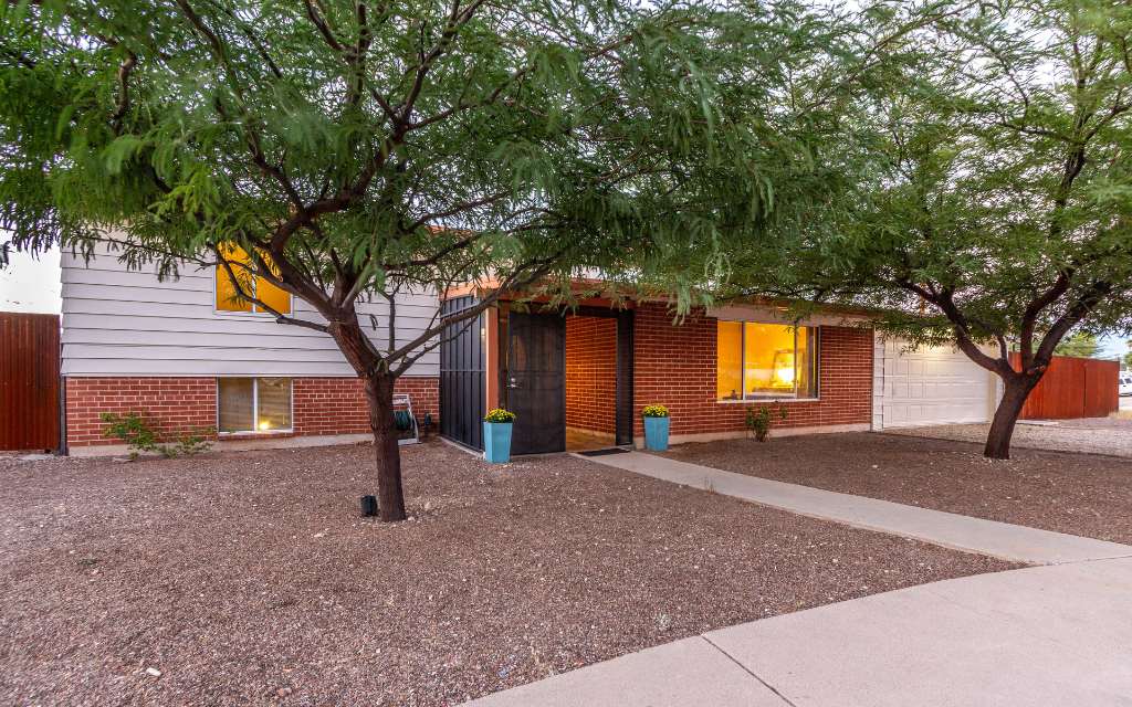 A red brick split level home with 2 mesquite trees providing plenty of shade. Located at 357 N Sarnoff Dr Tucson Arizona 85710.