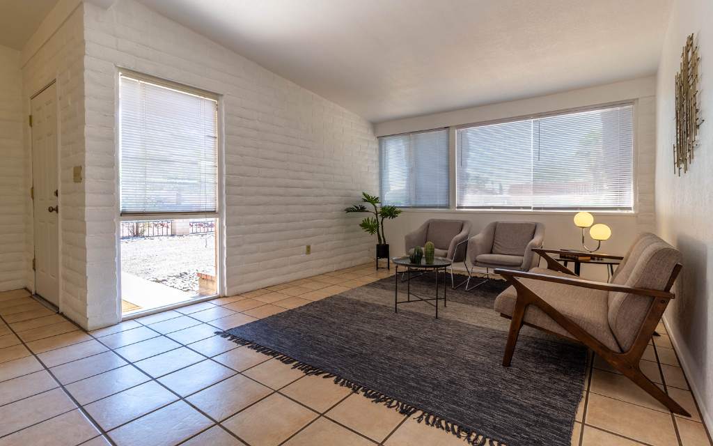 A modest 2 bed, 1 bath home is staged with living room furnishings.