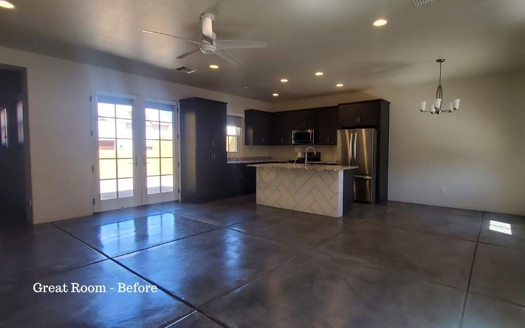 Before photo of a vacant great room looking onto the kitchen.