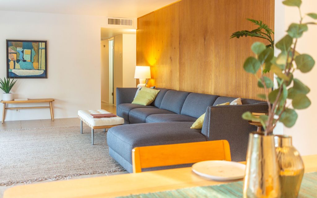 Living room with mahogany paneling behind the sofa in the living room