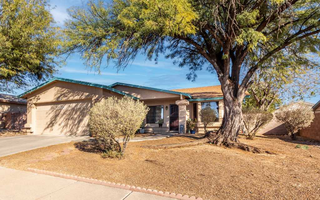 Well kept home with a new roof in a quiet east side Tucson neighborhood with a large mesquite tree in the front yard.